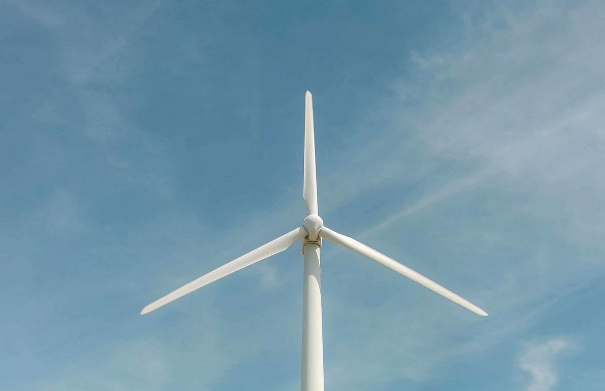 Windmill turbine on a blue sky