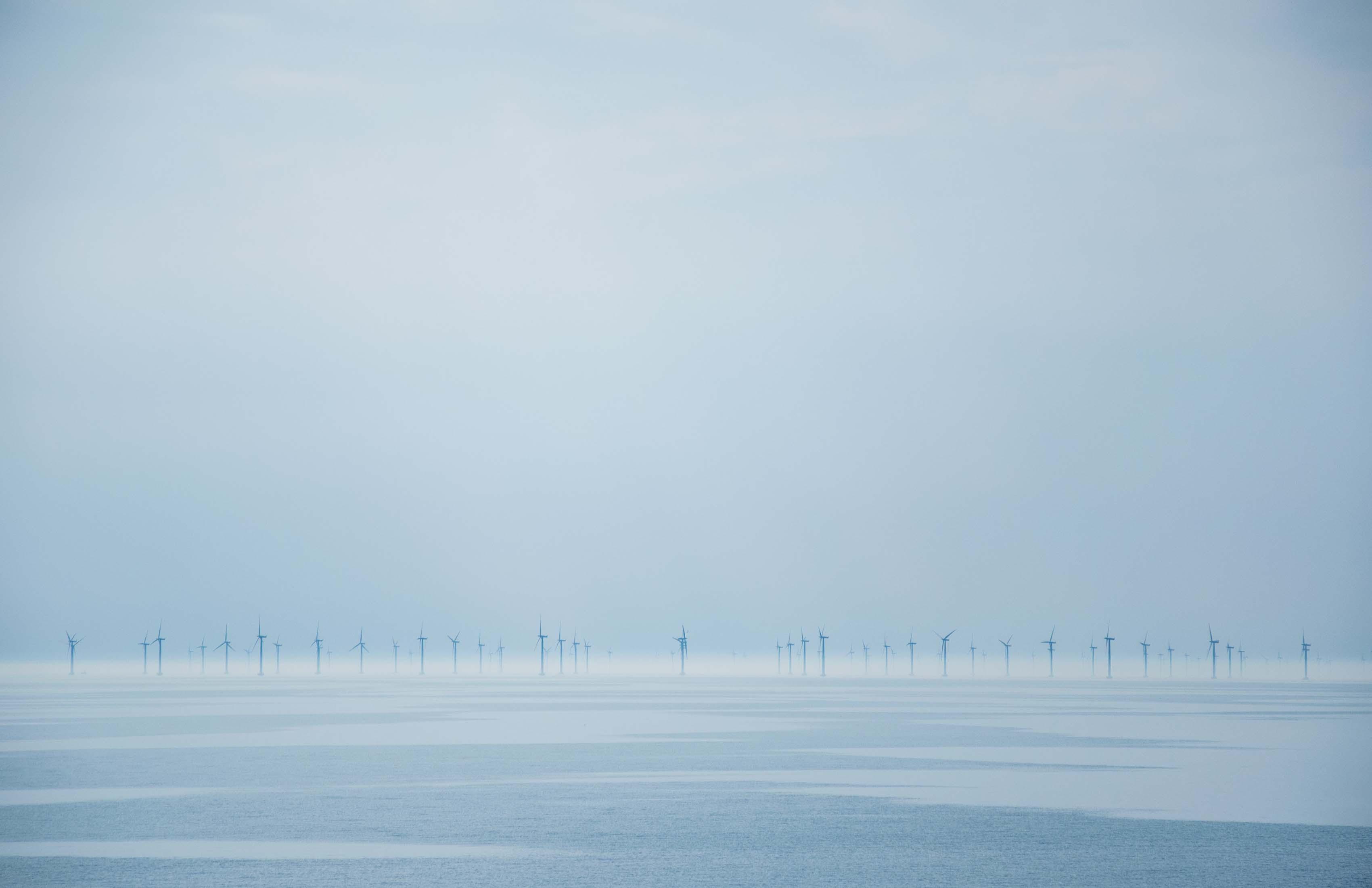 Windmill turbines in the distance on a winter day