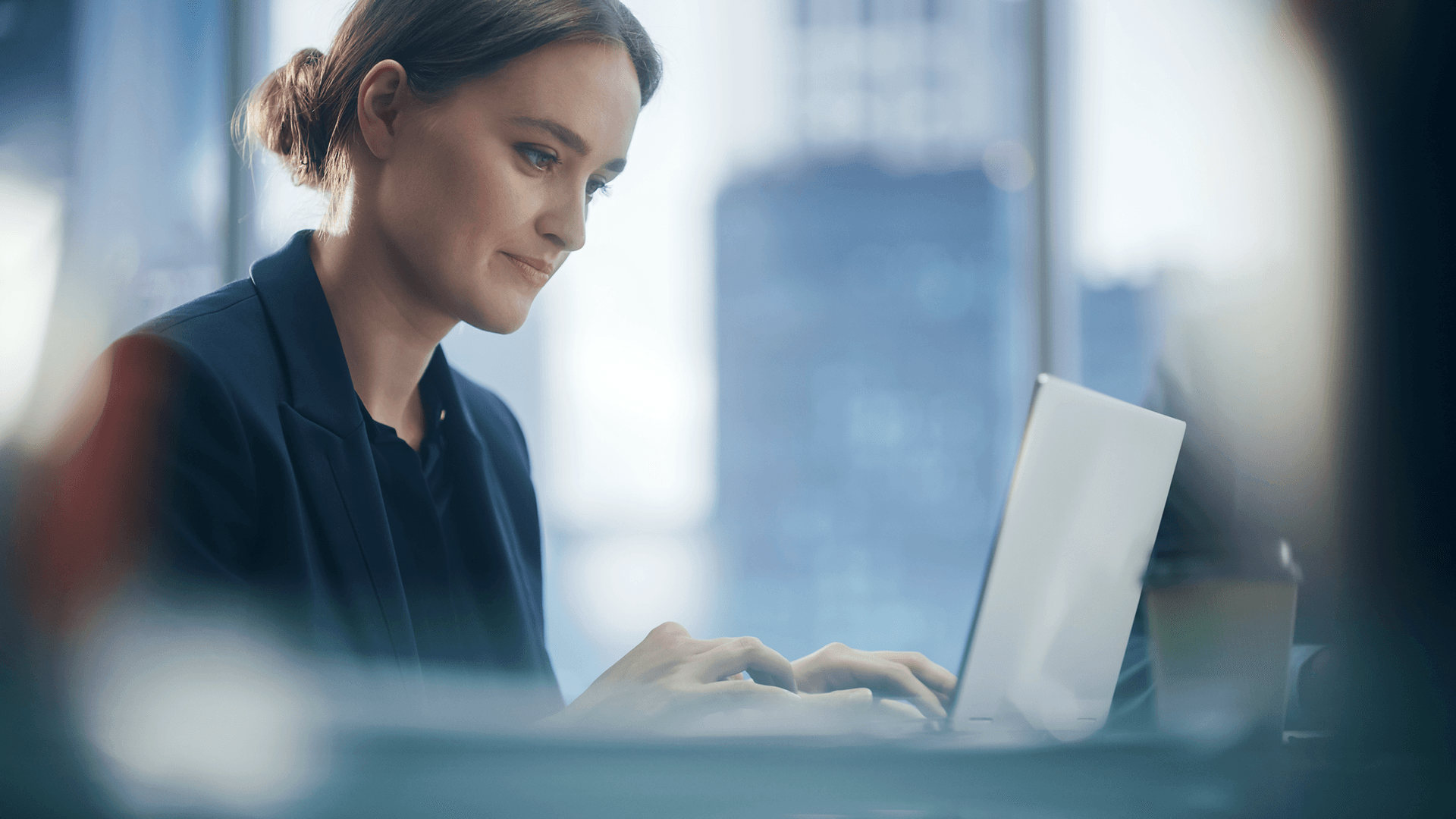 Adult woman working on a laptop in the office