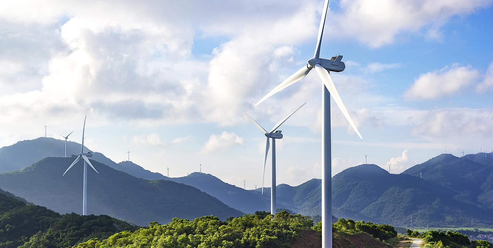 windmills and mountains in the background