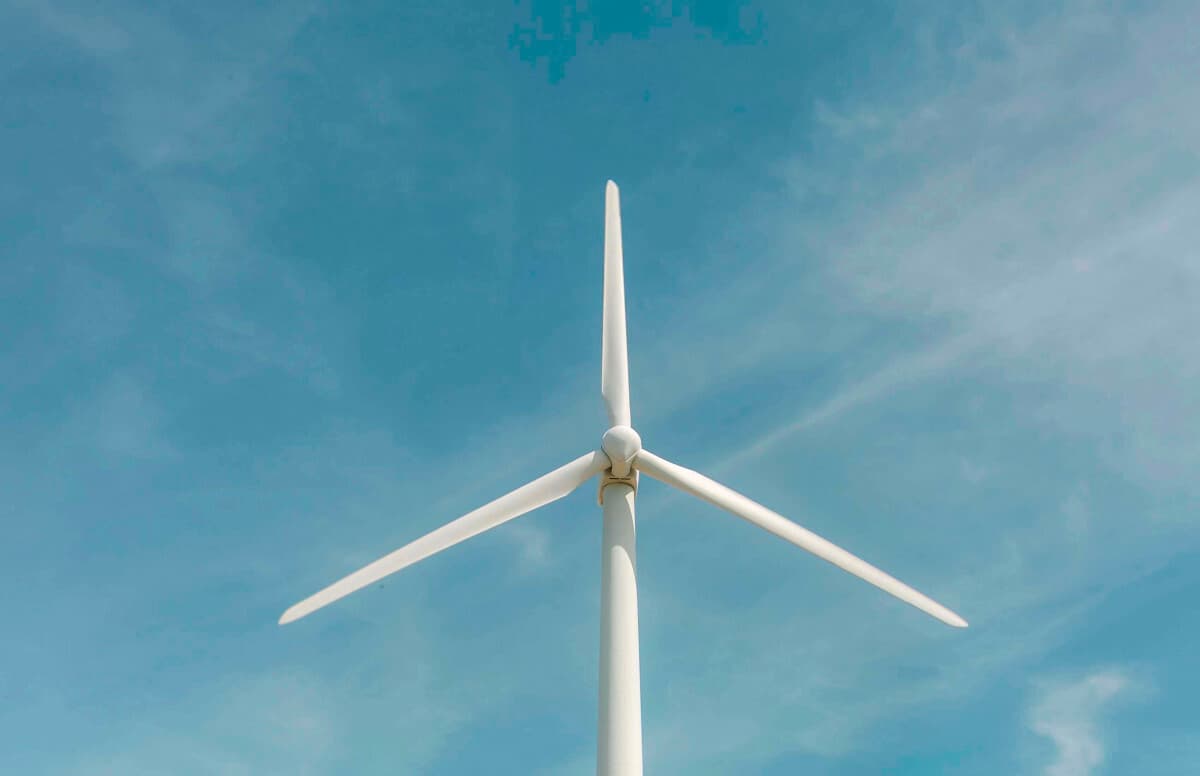 Wind turbine on sky background