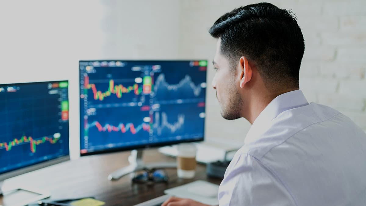 Man working in the office looking at stock charts