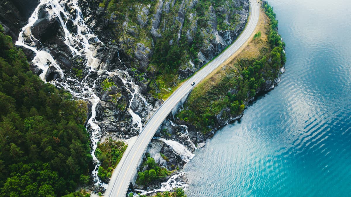 Picture of a road along costline and a waterfall