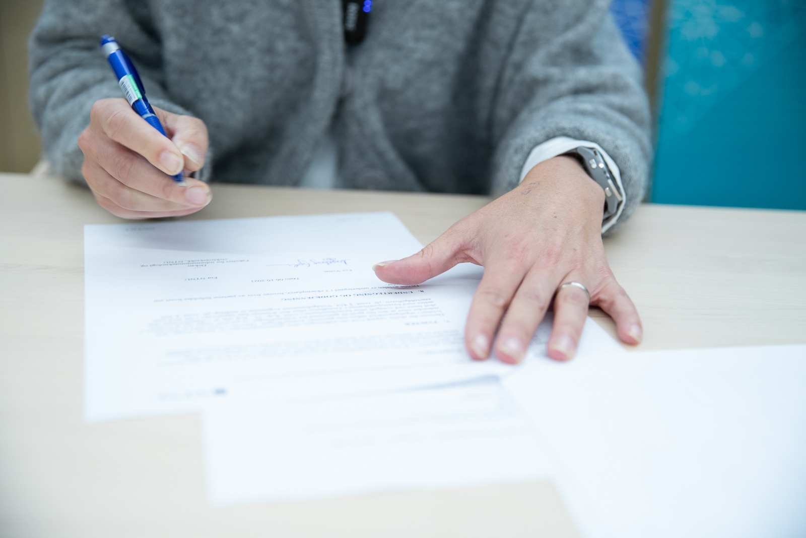 Someone signs a document