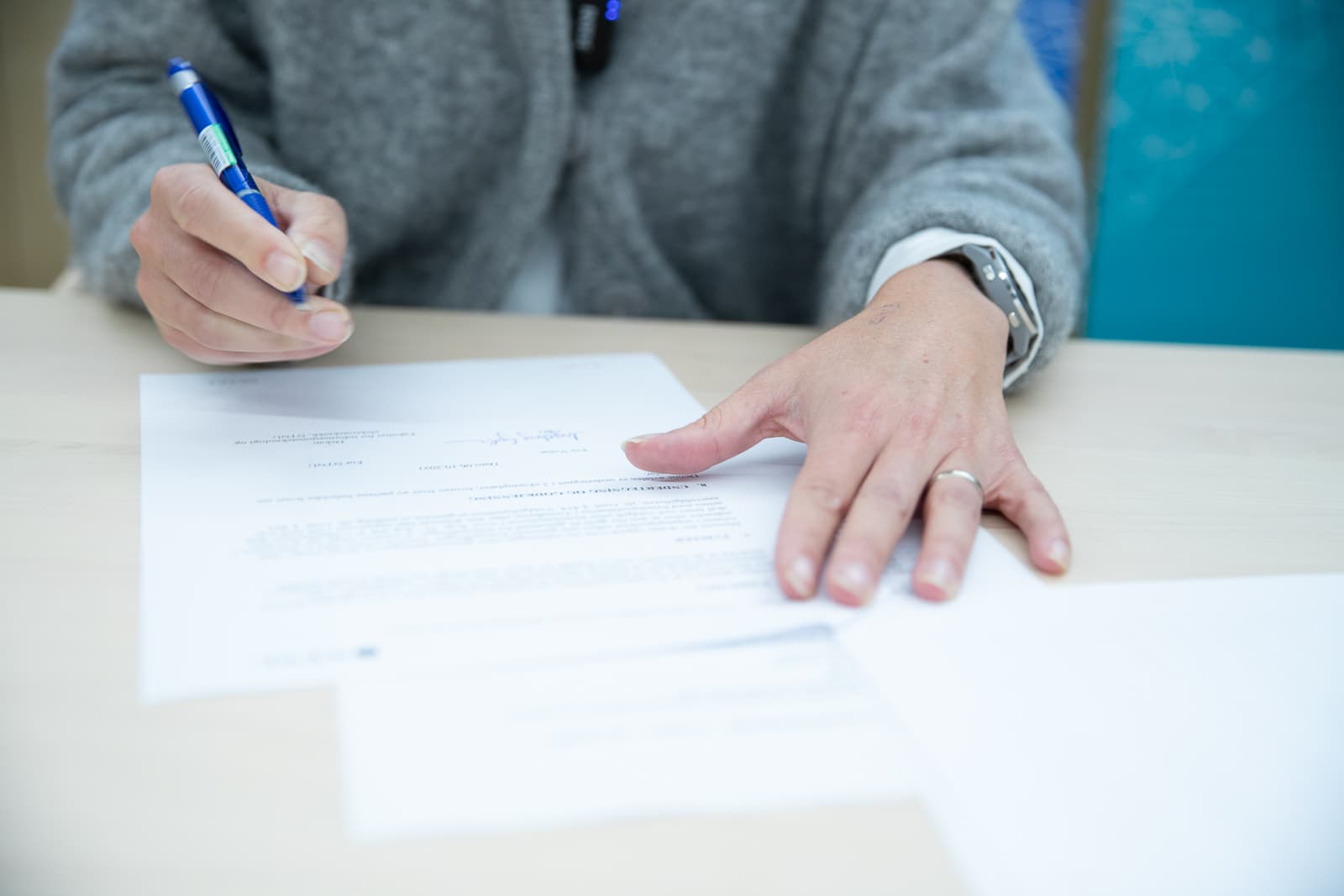 Someone signs a document