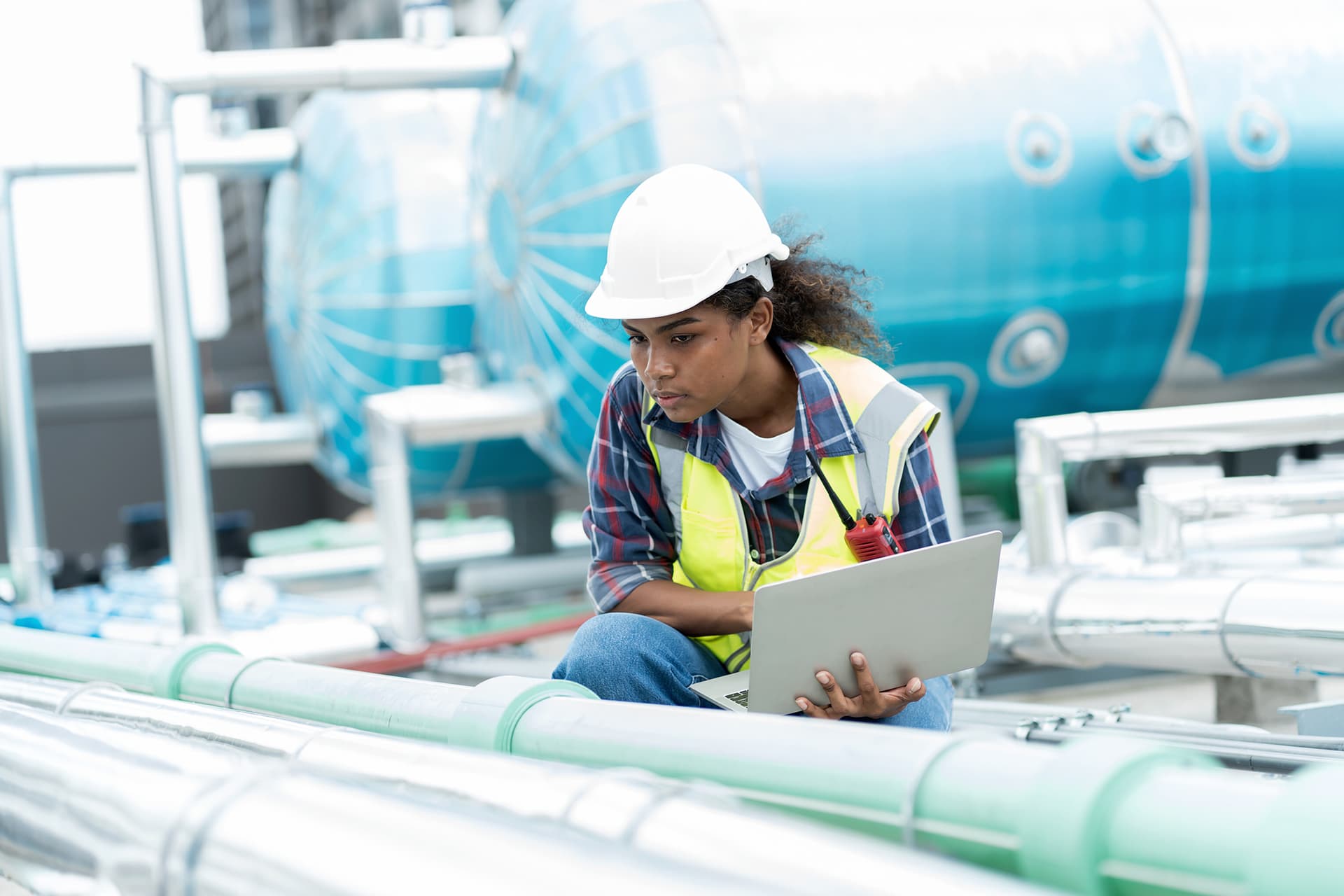 A person working on a laptop at the hydro plant
