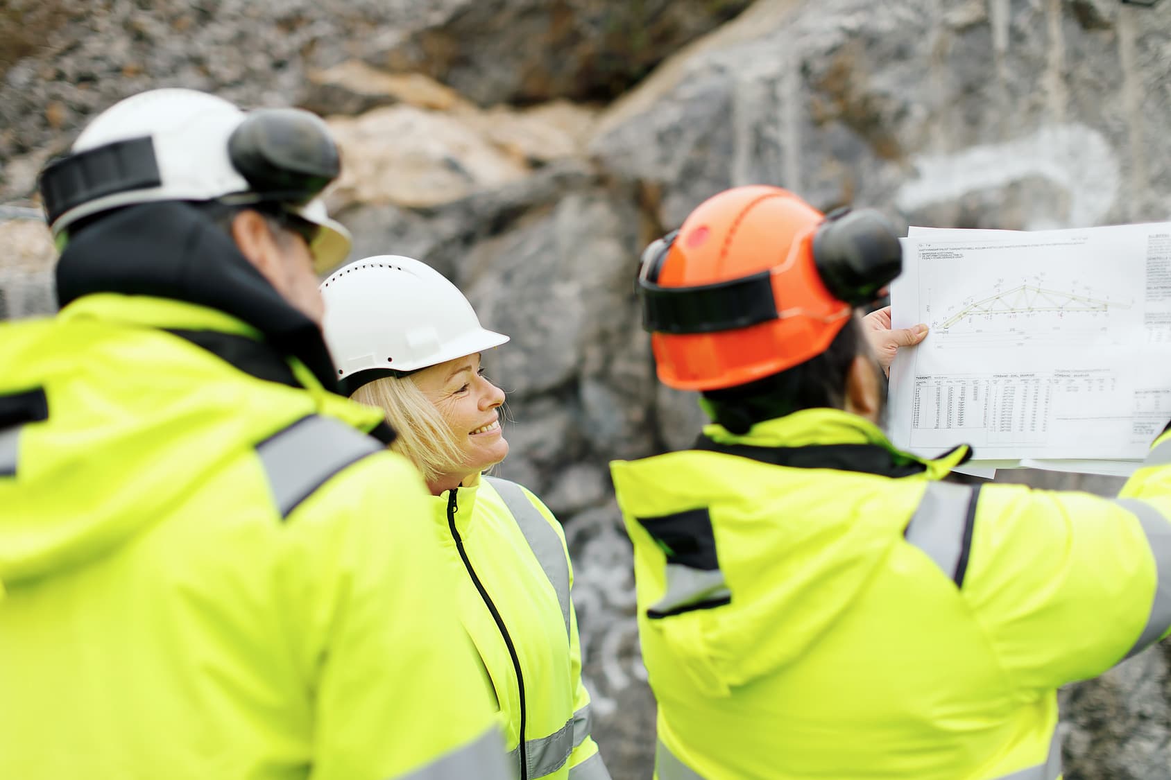 Image of Engineers in reflective clothing discussing plans to represent Gemini Terrain
