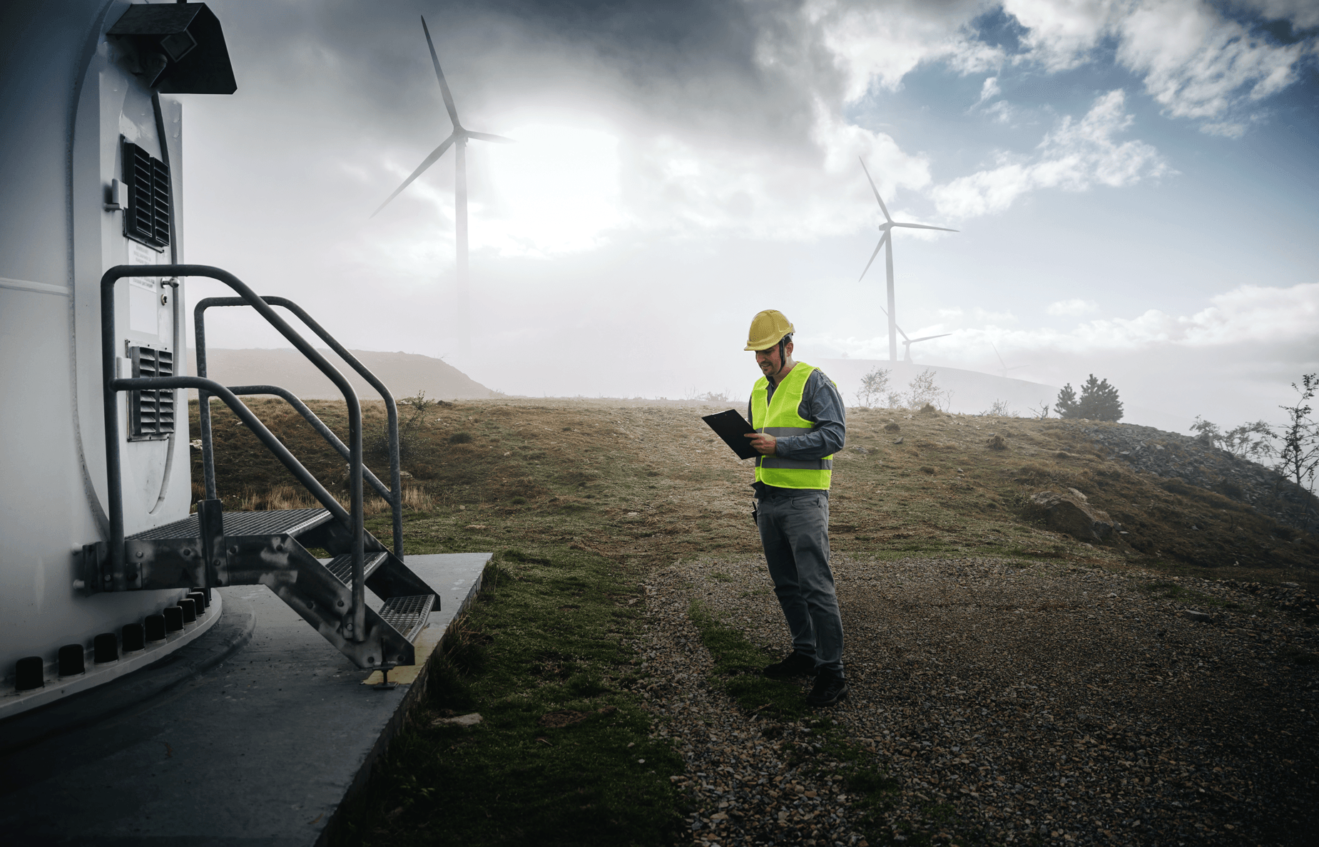 technician in front of a wind mill