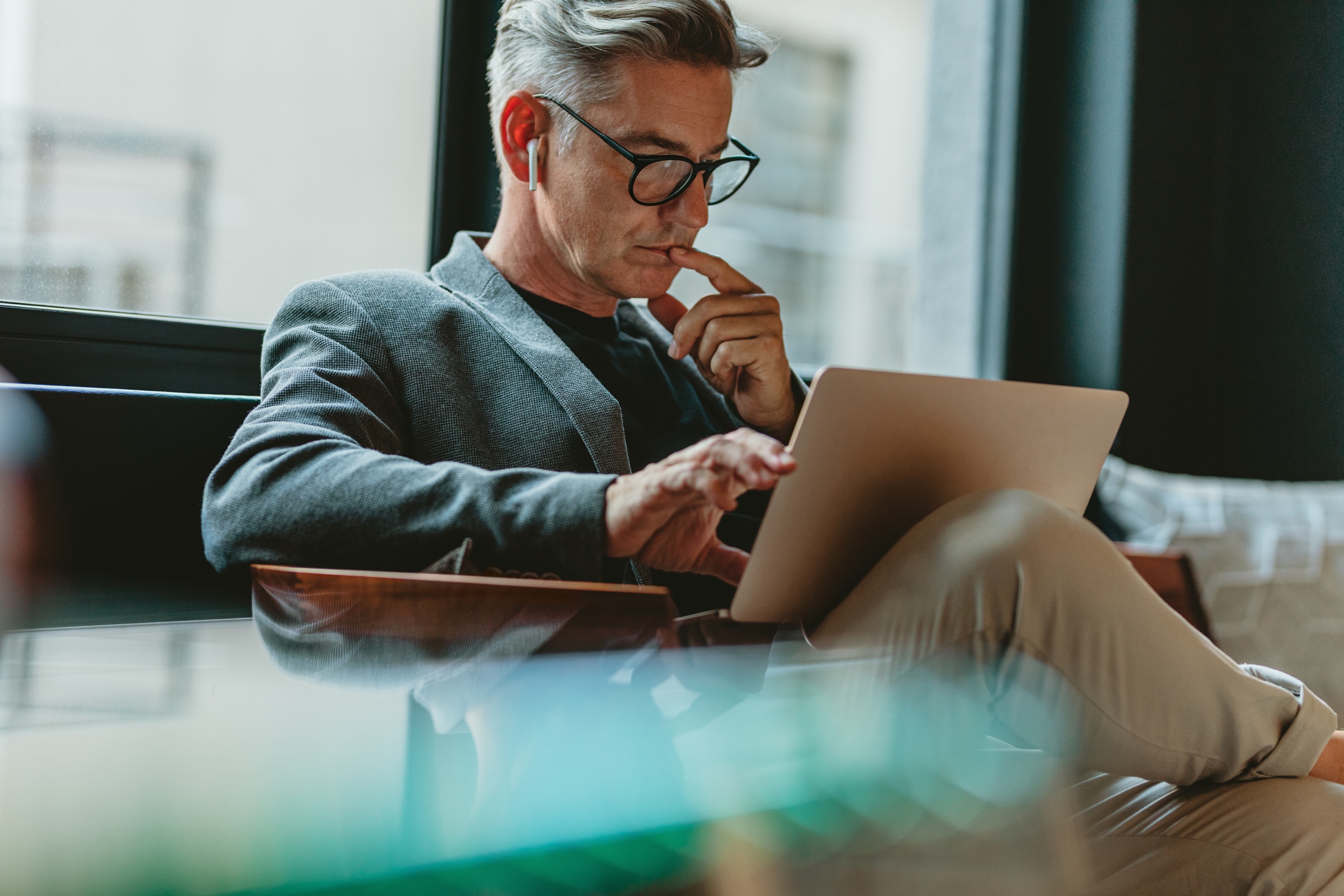 Picture of man following a webinar on laptop